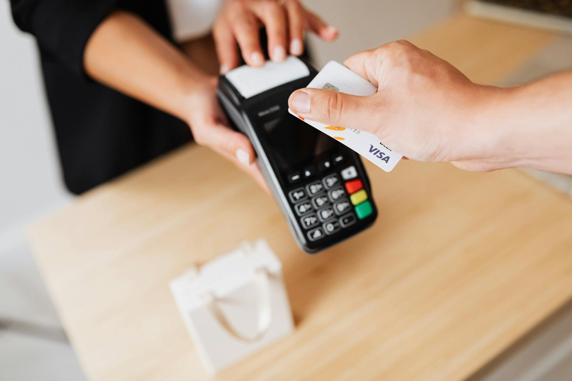 a person paying cashless using credit card